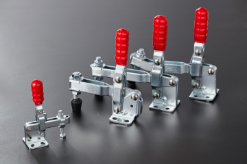 Vertical acting toggle clamps